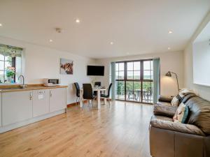 a living room with a couch and a kitchen and a table at 1 Bed in Bristol oc-72835 in Chew Magna