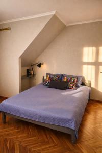 a bed with purple sheets and pillows in a bedroom at Muzeja apartamenti & Free Parking & Self Check-in in Riga