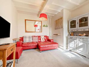 a living room with a red couch and a tv at 1 Bed in Kidderminster oc-82957 in Cleobury Mortimer
