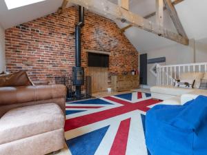 a living room with a brick wall and a couch at 5 Bed in Leek oc-79543 in Grindon