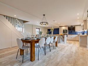 a kitchen and dining room with a table and chairs at 5 Bed in Leek oc-79543 in Grindon