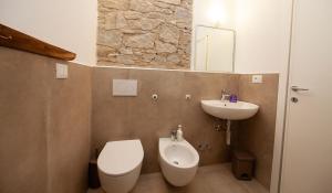 a bathroom with a toilet and a sink at Agriturismofaucci in Campo nell'Elba +70 photos