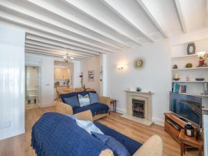 a living room with a blue bed and a fireplace at 2 Bed in Aberdyfi oc-dy047 in Aberdyfi
