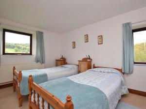 a bedroom with two beds and a window at 2 Bed in High Peak oc-pk551 in Hayfield
