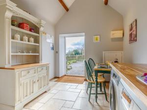 a kitchen with a counter and a table and chairs at 1 Bed in Wotton -under- Edge oc-earba in Charfield