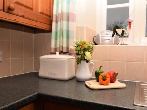 a kitchen counter with vegetables and a toaster at 2 Bed in Cirencester oc-cc094 in Ewen +5 photos