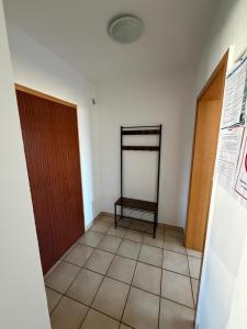 a hallway with two doors and a tiled floor at Deichnest in Hollern-Twielenfleth