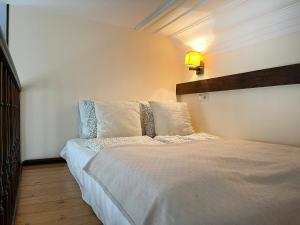 a bedroom with a bed with white sheets and pillows at Beautiful Studio for 4 guests, Main Square, Cracow in Krakow