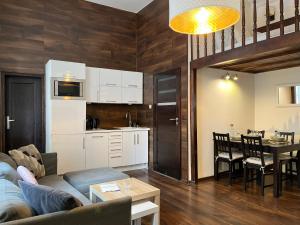 a living room and kitchen with a couch and a table at Beautiful Studio for 4 guests, Main Square, Cracow in Krakow