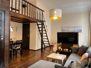 a living room with a couch and a loft at Beautiful Studio for 4 guests, Main Square, Cracow in Krakow