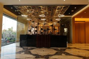 a lobby with a table and a wall of glass at Manratan Resort in Narsinghgarh +96 photos
