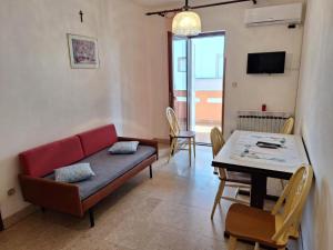 a living room with a couch and a table at Apartmani Štefica in Razvala