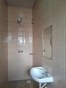 a bathroom with a sink and a shower with a mirror at Pivot Studio near Westside mall in Nakuru +10 photos