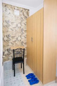 a black chair sitting in a room with a wall at Pivot Studio near Westside mall in Nakuru