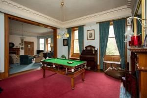 a living room with a pool table in it at Dalvey House in Forres