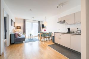 a kitchen and living room with a couch and a table at V7 Boutique Appartements in Freiburg im Breisgau