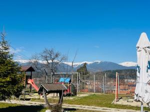 a park with a playground with mountains in the background at Апартамент за гости in Razlog