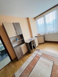 an empty room with a desk and a large window at Апартамент за гости in Razlog +23 photos