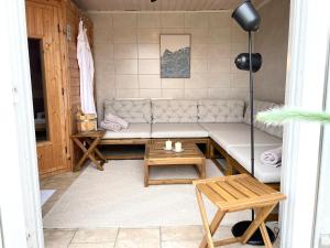 a living room with a couch and a table at Landhaus Markerup - großzügig mit Kamin, Sauna & Spielhaus in Husby