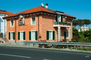 a house on the side of a road with a street at Guest House Arancia145 in Ceriale
