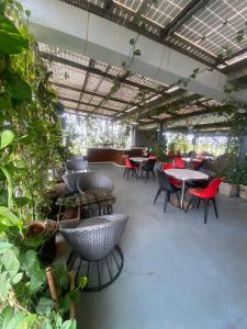 a restaurant with tables and chairs and plants at SRS Suites in Bangalore