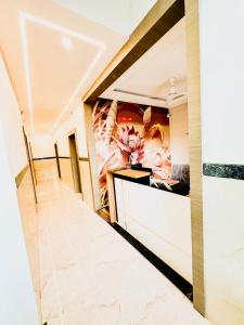 a lobby of a hotel with a painting on the wall at SHR Comfort Near Reva Circle Yelahanka in Bangalore
