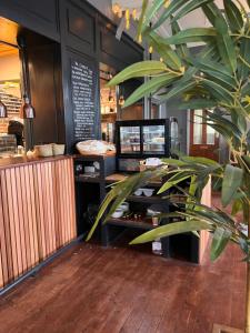 a restaurant with a potted plant in front of a counter at The Monsal in Monsaldale Station +32 photos