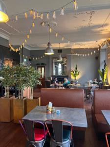 a restaurant with tables and chairs and people sitting at tables at The Monsal in Monsaldale Station