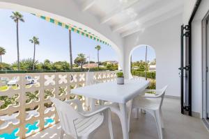 a white dining room with a white table and white chairs at Villa Mare a fabulous hideaway in S'Algar
