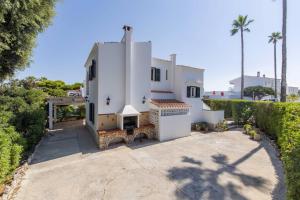 an aerial view of a white house with trees at Villa Mare a fabulous hideaway in S'Algar