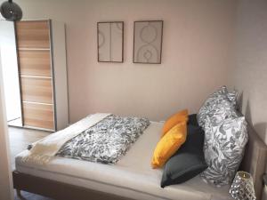 a couch with pillows on it in a room at Superior - Appartement Amélie in Potsdam