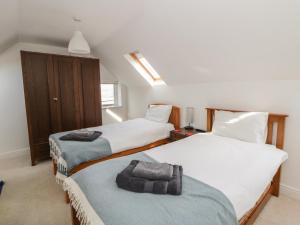 a bedroom with two beds with towels on them at Awen Ingli in Newport
