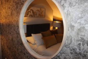 a mirror in a room with a bed in it at Blackburn Heights Sleeps 4 Family Apartment in Bridlington
