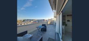 a balcony with chairs and a view of a city at Exceptional, 12 minutes RER C from Paris in Juvisy-sur-Orge
