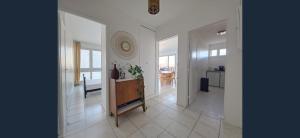 a large white hallway with a table in a room at Exceptional, 12 minutes RER C from Paris in Juvisy-sur-Orge