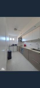 a large kitchen with white cabinets and a sink at Exceptional, 12 minutes RER C from Paris in Juvisy-sur-Orge