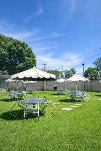 a group of chairs and tables with umbrellas at Pivot Studio near Westside mall in Nakuru