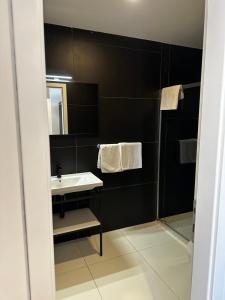 a bathroom with a sink and a mirror at Hotel Elu Iris in Split