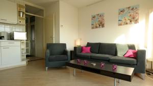 a living room with a couch and a coffee table at Appartement Boodtlaan 4E in De Koog