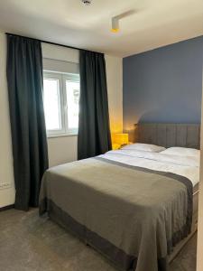 a bedroom with a large bed and a window at Hotel Elu Iris in Split