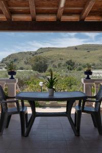 a table and two chairs on a porch with a view at 900 Dal Blu in Licata