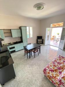 a kitchen with a table and a dining room at 900 Dal Blu in Licata