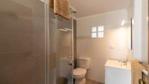 a bathroom with a shower and a toilet and a sink at Baleal Beach Stay in Baleal