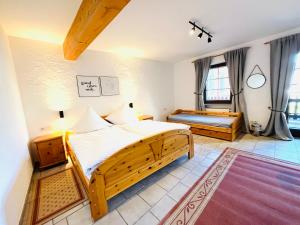 a bedroom with two beds and a rug at Hotel zum Anker in Detzem