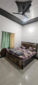 a large bed in a room with a ceiling at Thakur place in Mathura