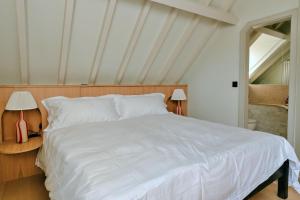 a bedroom with a white bed and two lamps at Finest Retreats - ARC Next-The-Sea in Wells next the Sea +28 photos