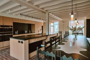 a dining room with a long table and chairs at Finest Retreats - ARC Next-The-Sea in Wells next the Sea