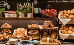 a bakery with different types of bread and pastries at Motel One Koblenz in Koblenz