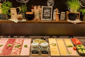 a display of different types of meats and vegetables at Motel One Koblenz in Koblenz