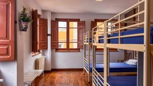 a room with two bunk beds in a hostel at Albergue Mayor in Sarria